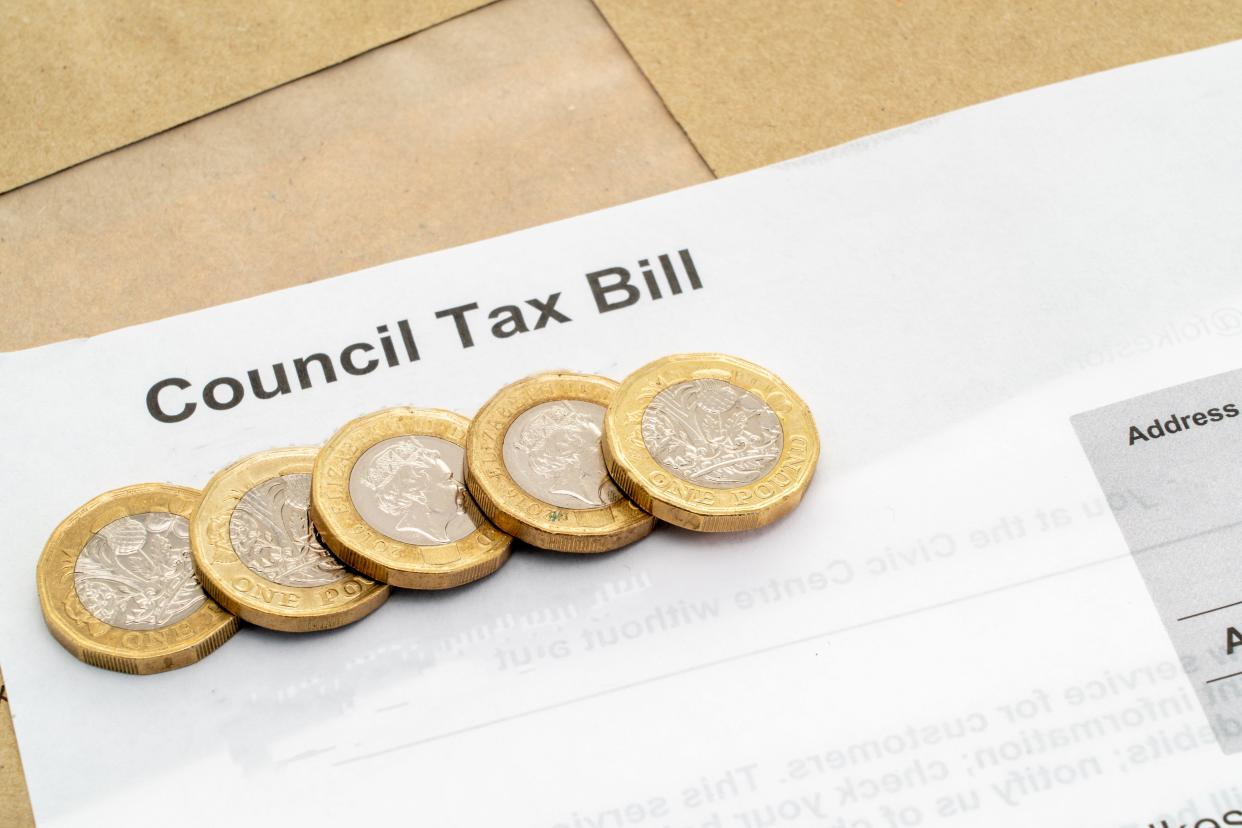 A  UK council tax bill with one pound coins