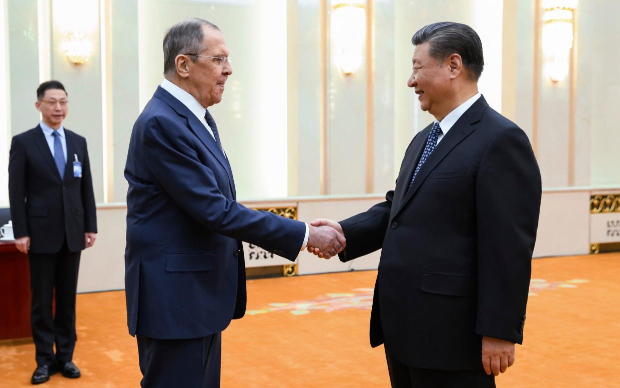 In this photo released by Russian Foreign Ministry Press Service on Tuesday, April 9, 2024, Russian Foreign Minister Sergey Lavrov and Chinese President Xi Jinping shake hands during their meeting in Beijing, China. Russian Foreign Minister Sergey Lavrov is visiting Beijing to display the strength of ties with close diplomatic partner China amid Moscow's grinding war against Ukraine. (Russian Foreign Ministry Press Service via AP)