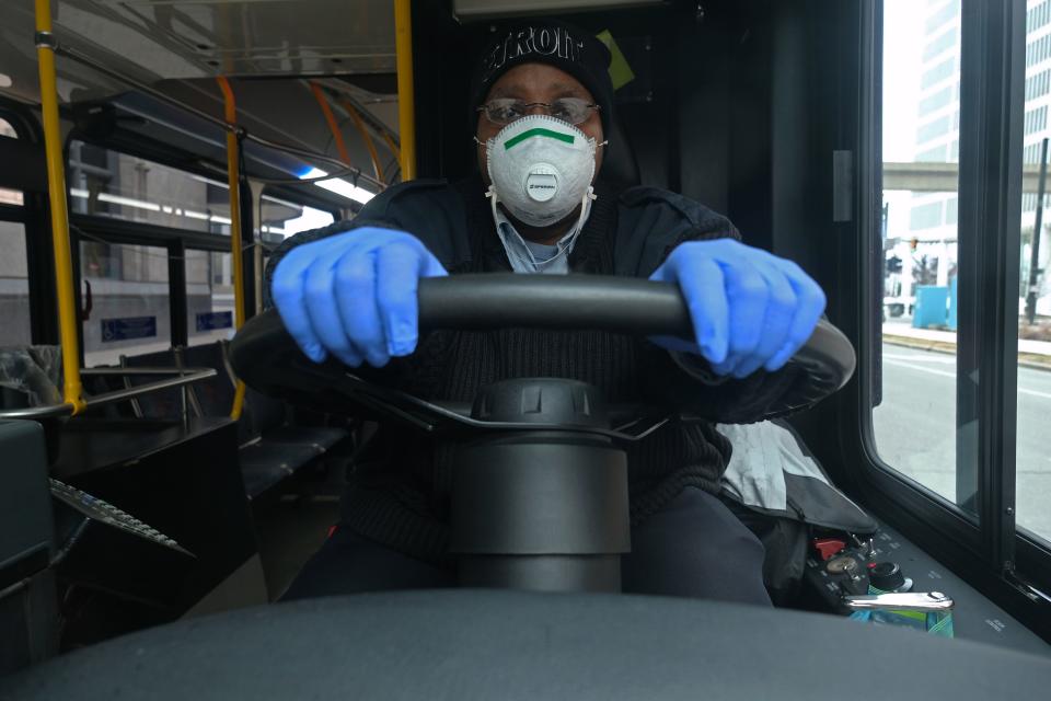 A bus driver for the Detroit, Michigan city bus line DDOT poses for a portrait wearing a protective mask and gloves for protection in Detroit, Michigan, on March 24, 2020, during the novel coronavirus (COVID-19) outbreak. - At 12:01 am Tuesday March 24,2020 Governor Gretchen Whitmer ordered a 'Stay at Home and Stay Safe Order' to slow the spread of Coronavirus (COVID-19) across the State of Michigan which now has 1,791 confirmed cases and 24 deaths due to the virus. (Photo by SETH HERALD / AFP) (Photo by SETH HERALD/AFP via Getty Images)