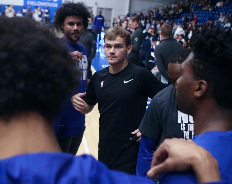 NBA slam dunk contest winner Mac McClung, center, joins a team huddle at the start of his return to the Blue Coats in a G League game at the Chase Fieldhouse on Wednesday, Feb. 22, 2023.