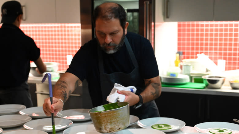 Enrique Olvera plates several dishes 