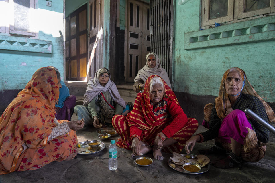 After their visit to Pashupatinath temple, Indian pilgrims eat their meal before preparing for their departure in Kathmandu, Nepal, Jan. 5, 2024. The centuries-old temple is one of the most important pilgrimage sites in Asia for Hindus. Nepal and India are the world’s two Hindu-majority nations and share a strong religious affinity. Every year, millions of Nepalese and Indians visit Hindu shrines in both countries to pray for success and the well-being of their loved ones. (AP Photo/Niranjan Shrestha)