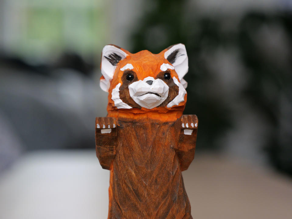 Close up photo of a wooden red panda toy