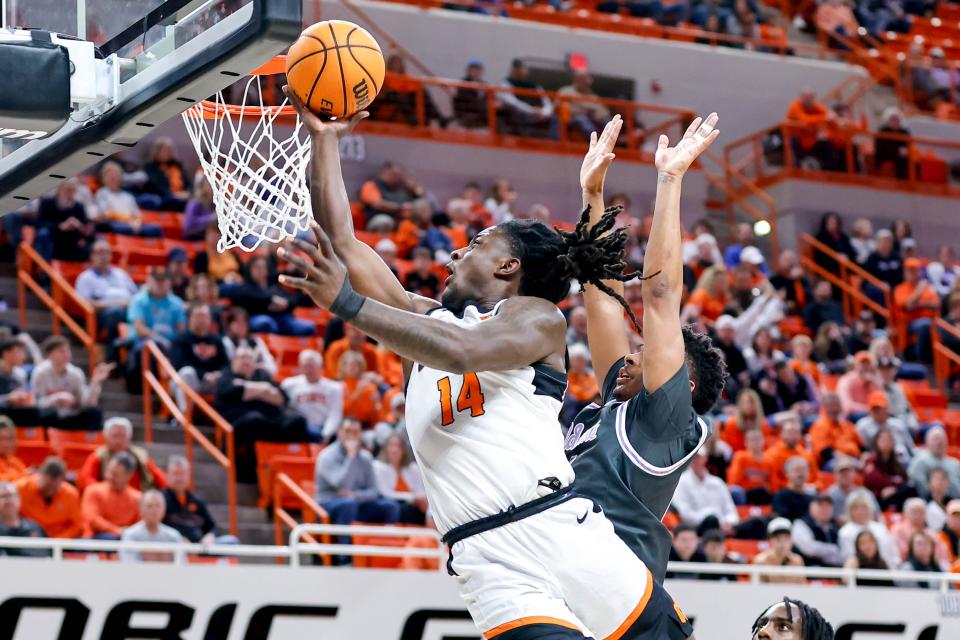 Oklahoma State guard Jamyron Keller (14) lays up the ball in the first half during an NCAA basketball game between Oklahoma State (OSU) and Kansas State (KSU) at the Gallagher-Iba Arena in Stillwater Okla., on Saturday, Feb. 3, 2024.