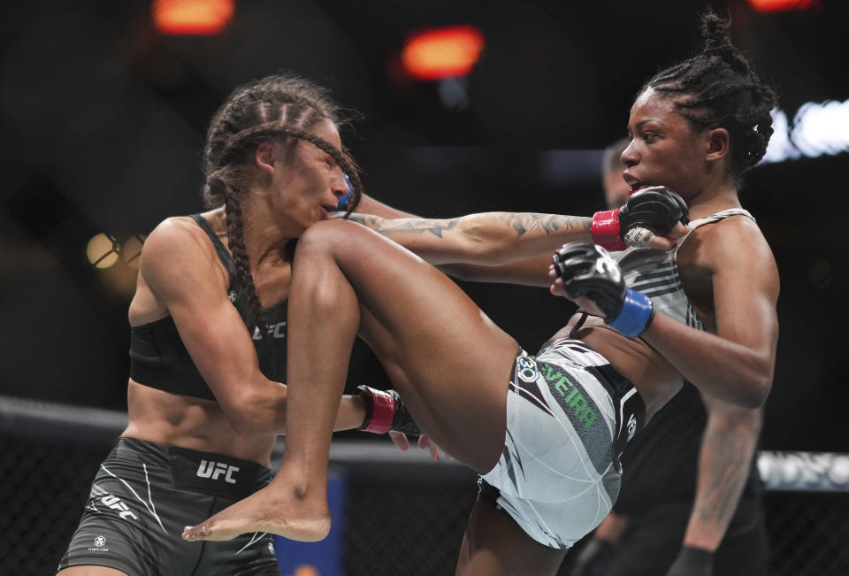 Maria Oliveira, right, delivers a knee to the face of Diana Belbita during a women's strawweight bout at UFC 289 in Vancouver, British Columbia on Saturday, June 10, 2023. (Darryl Dyck/The Canadian Press via AP)