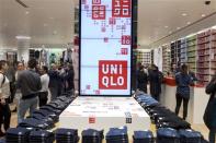 People visit the Uniqlo Global flagship store during a preopening in Berlin, April 10, 2014. REUTERS/Axel Schmidt