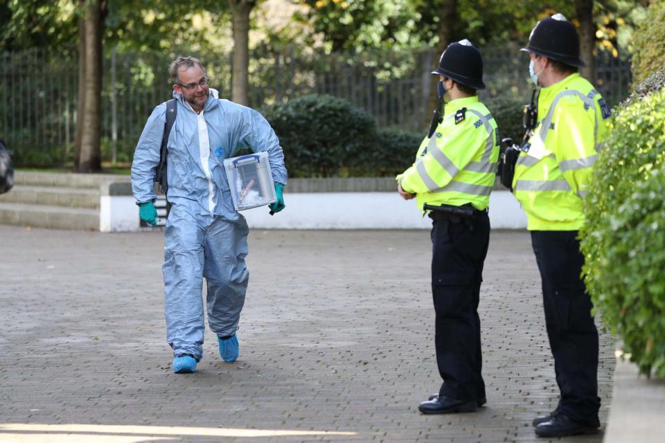 Forensic officers in Brentford, west London, after a mother, father and their son were found dead (PA)