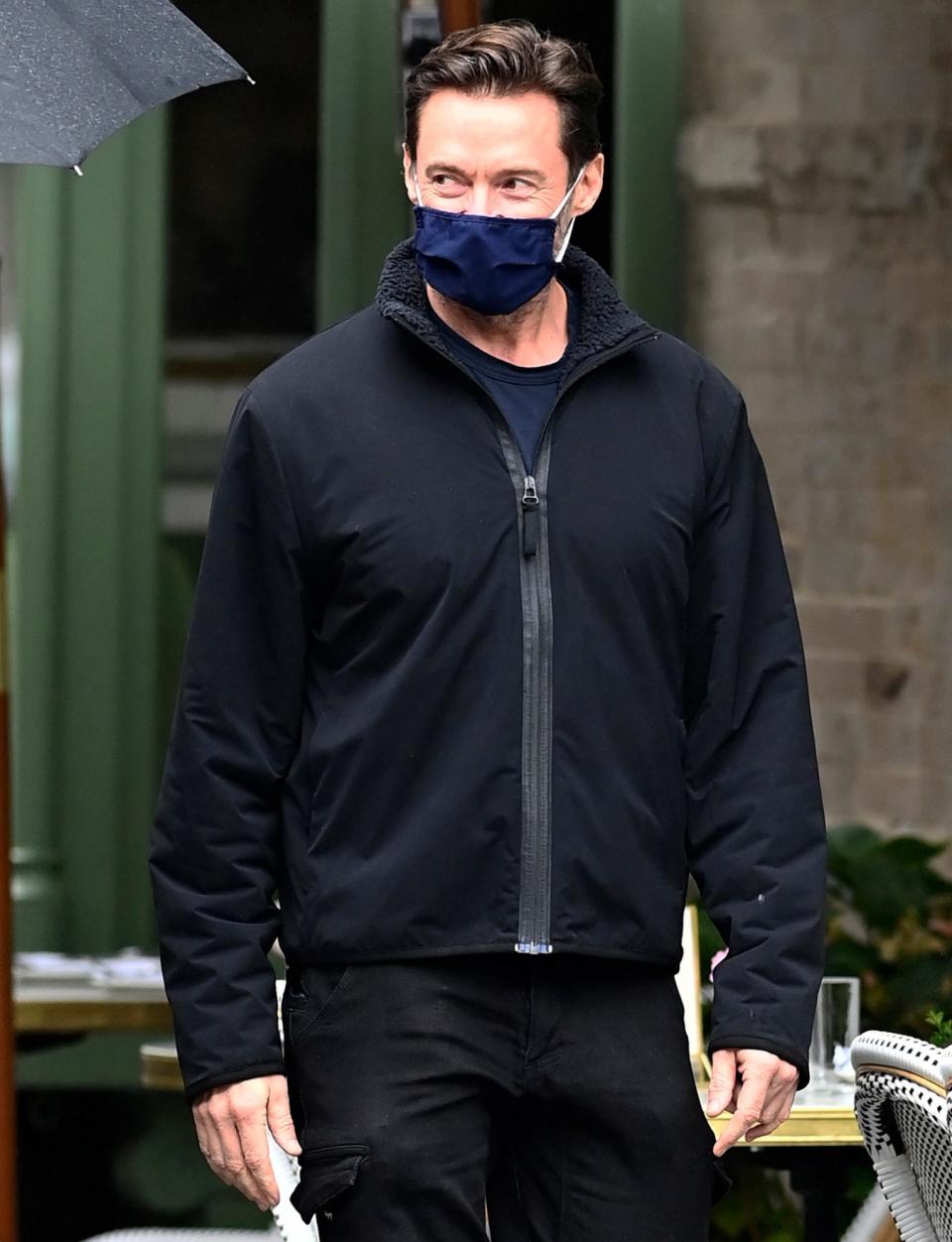 <p>Hugh Jackman seems to be smiling beneath his face mask as he walks to lunch with a friend in N.Y.C. on Monday.</p>