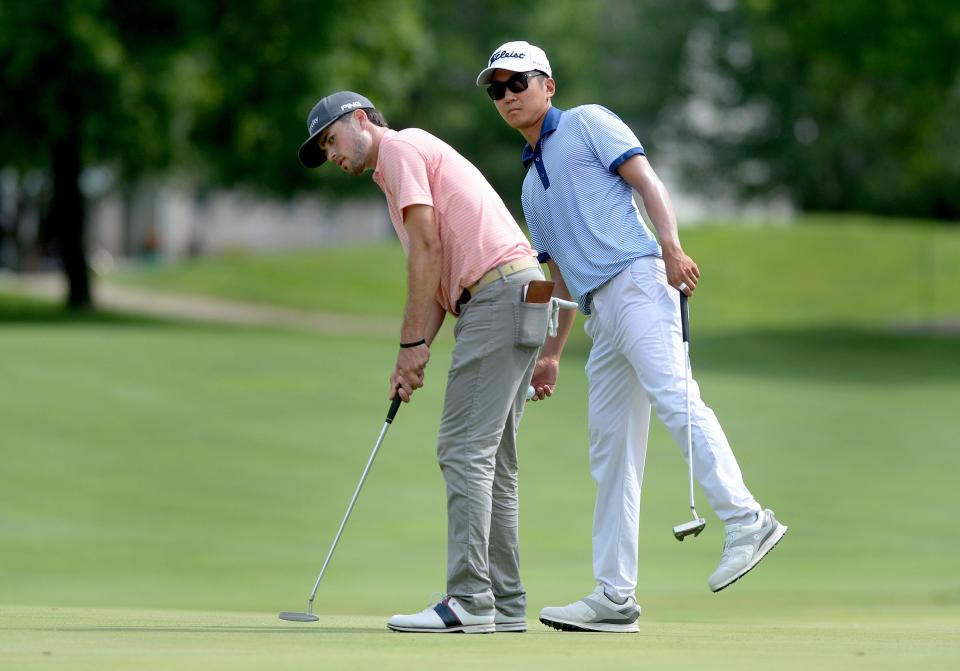 Michael Kim, right, looks over the shoulder of Cole Hammer's as Hammer putts on the 12th green during the Korn Ferry Tour Memorial Health Championship Saturday July 16, 2022.