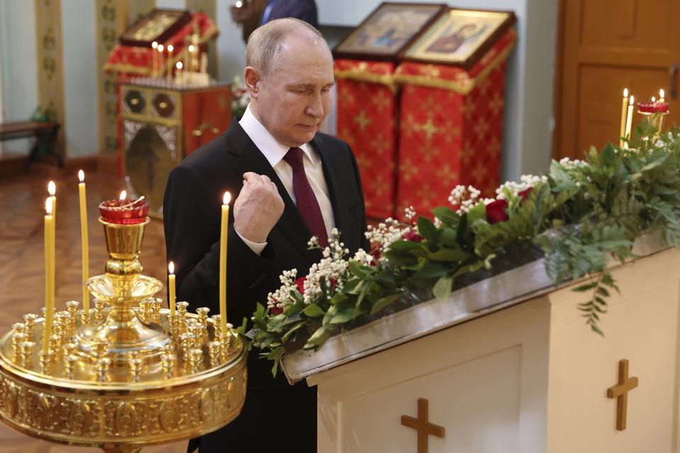 Russian President Vladimir Putin crosses himself as he visits the Church of the Intercession of the Mother of God in Harbin, northeastern China's Heilongjiang Province, on Friday, May 17, 2024. (Alexander Ryumin, Sputnik, Kremlin Pool Photo via AP)