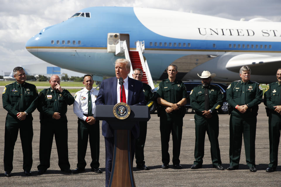 With Air Force One in the background, President Donald Trump speaks during a campaign event with Florida Sheriffs in Tampa, Fla., Friday, July 31, 2020. (AP Photo/Patrick Semansky)