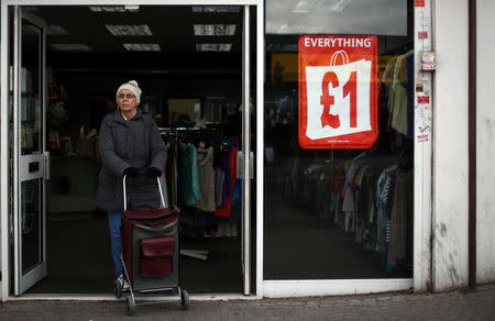 A woman leaves a charity shop in Dagenham, east London, Britain, March 18, 2019. REHannah McKay