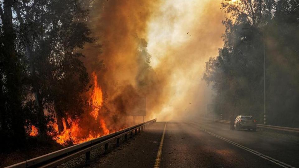 Flames seen at the side of a road, amid ongoing cross-border hostilities between Hezbollah and Israeli forces, close to the Israel border with Lebanon, in northern Israel, June 4, 2024.