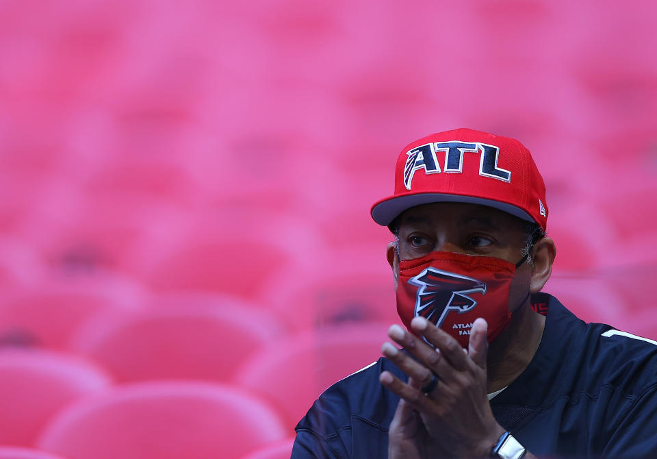 ATLANTA, GEORGIA - AUGUST 13:  A masked fan cheers for the Atlanta Falcons during pregame warmups prior to facing the Tennessee Titans at Mercedes-Benz Stadium on August 13, 2021 in Atlanta, Georgia. (Photo by Kevin C. Cox/Getty Images)