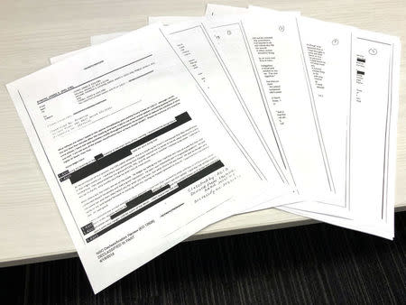 The partially redacted memos of former FBI Director James Comey, recounting conversations with President Donald Trump last year, are pictured after U.S. Justice Department released them to three House of Representatives committees in Washington, DC, U.S., April 19, 2018. REUTERS/Gavino Garay