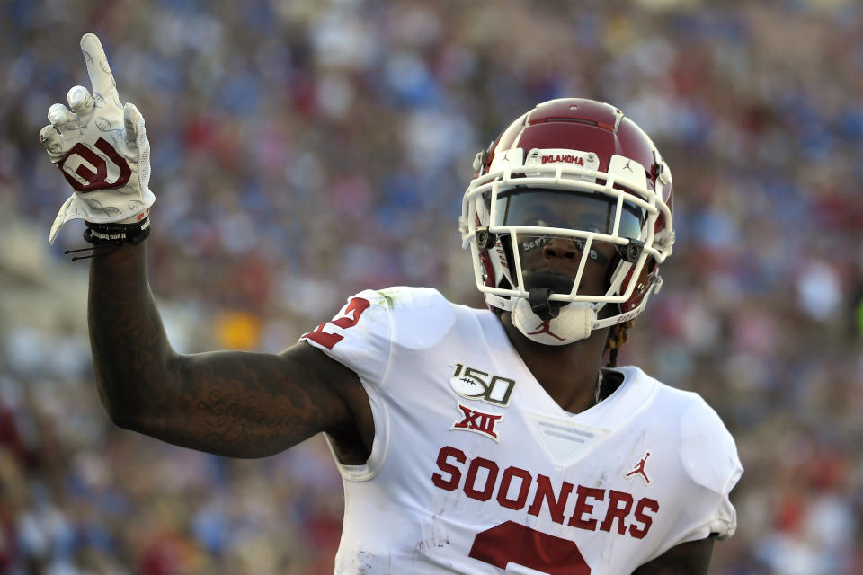 FILE - In this Sept. 14, 2019, file photo, Oklahoma wide receiver CeeDee Lamb celebrates after scoring a touchdown during the first half of an NCAA college football game against UCLA, in Pasadena, Calif. Lamb was selected to the AP Midseason All-America NCAA college football team, Tuesday, Oct. 15, 2019. (AP Photo/Mark J. Terrill)