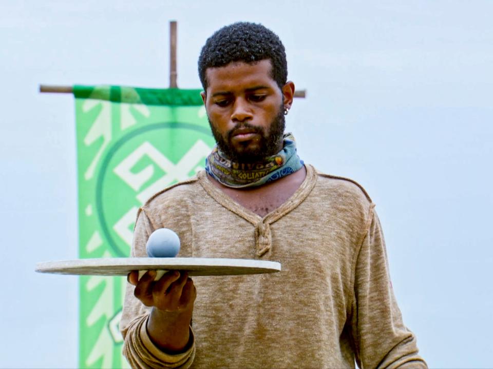 The contestant Davie Rickenbacker holds a plate with two round objects on it.