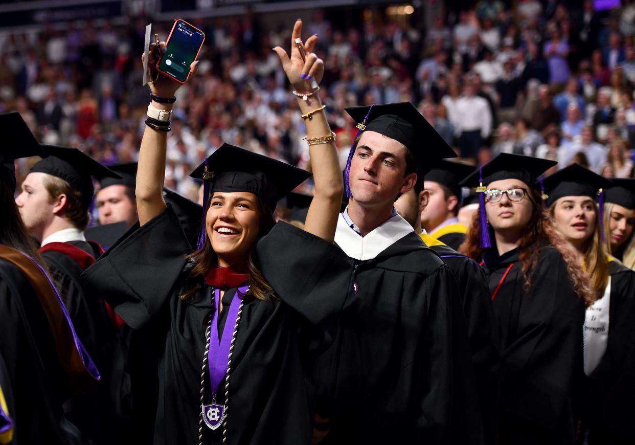 Gabriella Venezia of Watertown reacts as families cheer during the College of the Holy Cross' 177th graduation ceremony at DCU Center Friday morning.