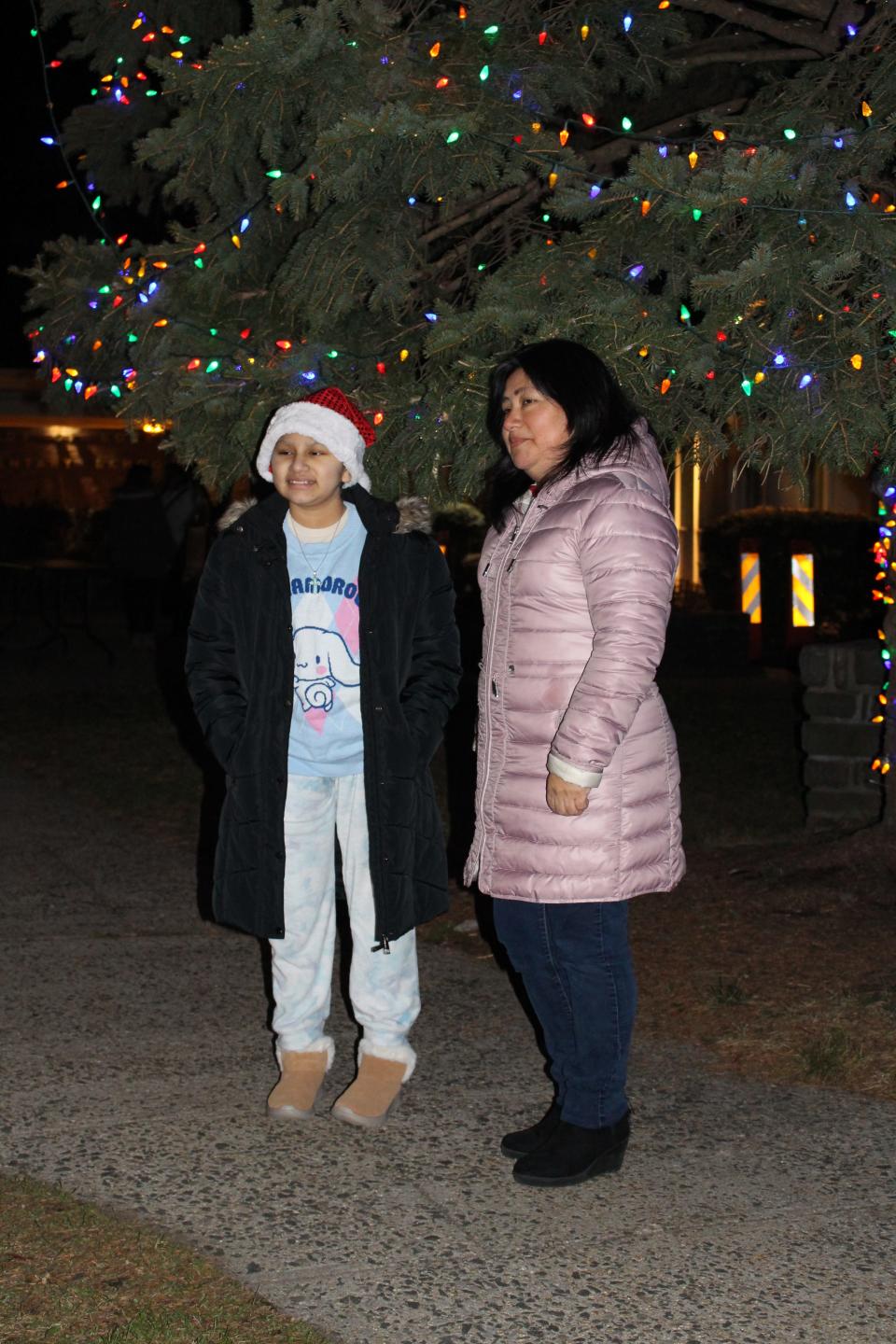 Myra Cacsire, 11, and her mother Patricia at a Christmas tree lighting held in her honor at Our Lady of Sorrows School in White Plains.