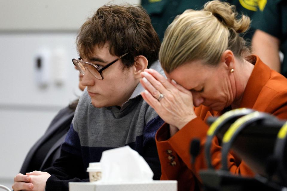 Assistant Public Defender Melisa McNeill, seated with Marjory Stoneman Douglas High School shooter Nikolas Cruz, listens as the last of the 17 verdicts is read in the penalty phase of Cruz's trial at the Broward County Courthouse in Fort Lauderdale, Fla., on Thursday.