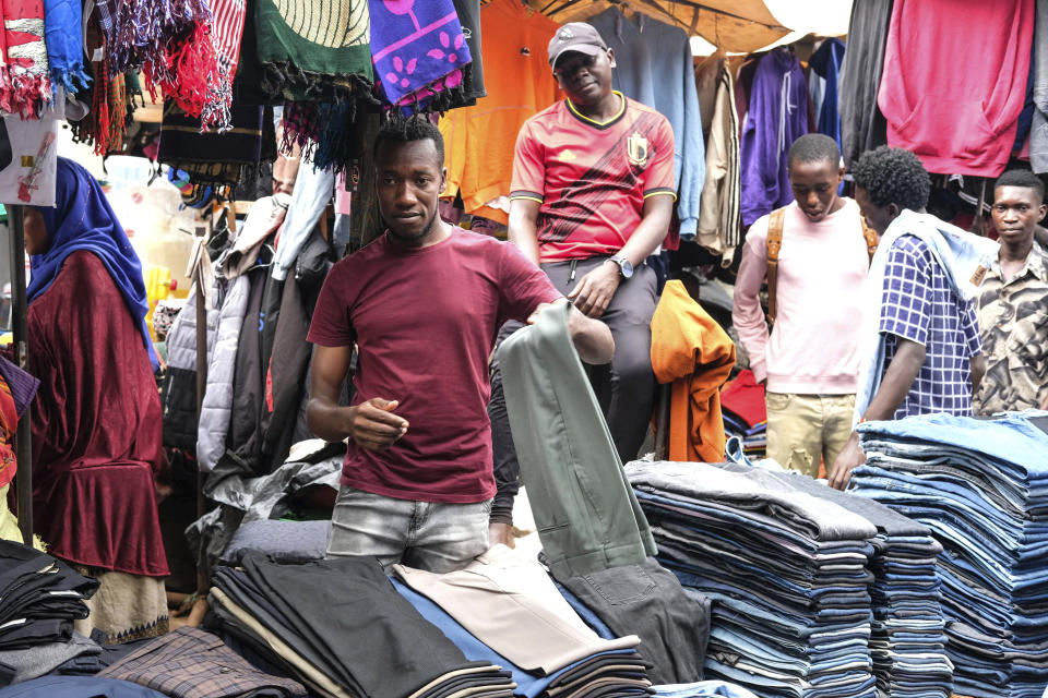 Walusimbi Tadewo, seller of secondhand clothes speaks during an interview with the Associated Press, at Owino market in Kampala, Uganda. Friday, Sept. 15, 2023. Downtown Kampala’s Owino Market has long been a go-to enclave for rich and poor people alike looking for affordable but quality-made used clothes, underscoring perceptions that Western fashion is superior to what is made at home. But, despite their popularity, secondhand clothes are facing increasing pushback. (AP Photo/Hajarah Nalwadda)