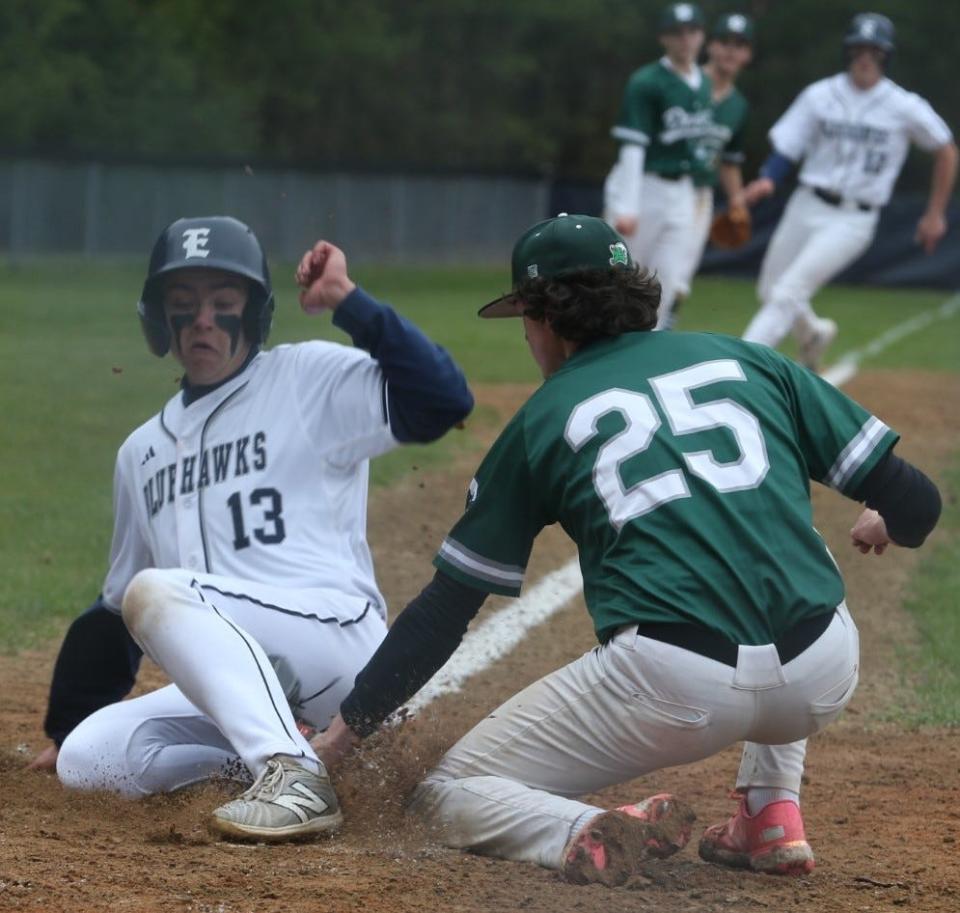 Exeter's Shea LaFleur slides safely into home plate before Dover pitcher Charlie Kubiet could apply the tag during Wednesday's Division I game at Exeter High School.