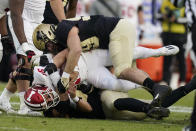 Indiana quarterback Grant Gremel (16) is sacked by Purdue's George Karlaftis (5) and Jack Sullivan (99) during the first half of an NCAA college football game, Saturday, Nov. 27, 2021, in West Lafayette, Ind.(AP Photo/Darron Cummings)