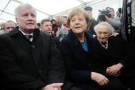 Bavarian leader Horst Seehofer (left), German Chancellor Angela Merkel and Holocaust survivor Max Mannheimer wait for the start of a ceremony to mark 70 years since the Nazi camp of Dachau was liberated by US forces, during a ceremony on May 3, 2015