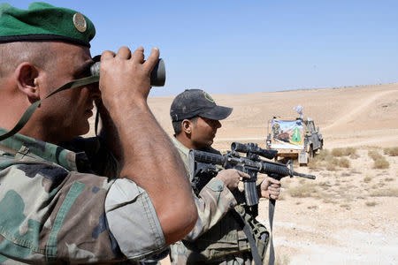 A Lebanese Army soldier looks through binoculars in Ras Baalbek, Lebanon August 28, 2017. REUTERS/ Hassan Abdallah