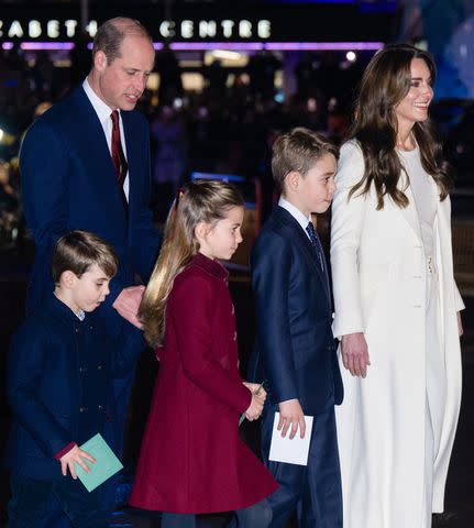 <p>Samir Hussein/WireImage</p> Prince Louis, Princess Charlotte and Prince George with their parents, Prince William and Kate Middleton, at the Christmas concert on Dec. 8, 2023