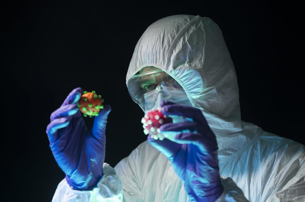 <span class="caption">The SARS-CoV-2 virus is mutating.</span> <span class="attribution"><a class="link " href="https://www.gettyimages.com/detail/photo/scientist-in-a-protective-suit-holds-and-compares-royalty-free-image/1285458686?adppopup=true" rel="nofollow noopener" target="_blank" data-ylk="slk:Aitor Diago/Moment via Getty Images;elm:context_link;itc:0;sec:content-canvas">Aitor Diago/Moment via Getty Images</a></span>