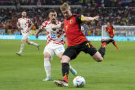 Belgium's Kevin De Bruyne, right, and Croatia's Josip Juranovic, left, fight for the ball during the World Cup group F soccer match between Croatia and Belgium at the Ahmad Bin Ali Stadium in Al Rayyan , Qatar, Thursday, Dec. 1, 2022. (AP Photo/Thanassis Stavrakis)