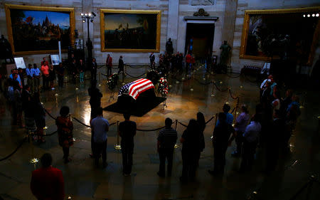 Mourners look at the casket containing the body of late U.S. Senator John McCain as it lies in state inside the U.S. Capitol Rotunda in Washington, U.S., August 31, 2018. REUTERS/Eric Thayer