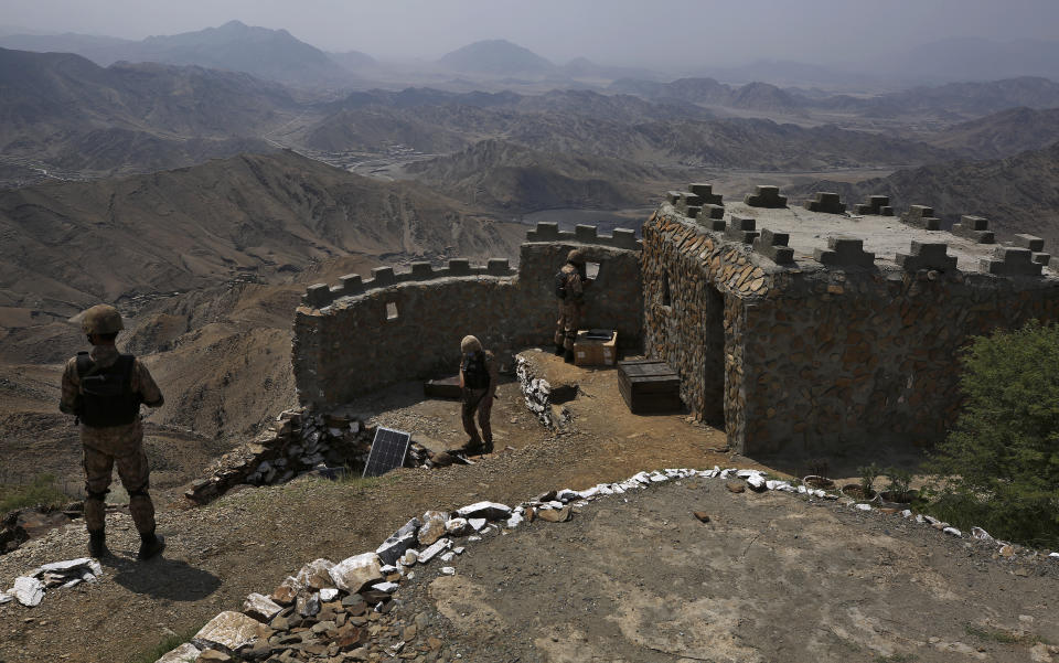 FILE - In this Aug. 3, 2021 file photo, Pakistan Army troops observe the area from hilltop post on the Pakistan Afghanistan, in Khyber district, Pakistan.The Taliban win in Afghanistan is giving a boost to militants in neighboring Pakistan. The Pakistani Taliban, known as the TTP, have become emboldened in tribal areas along the border with Afghanistan. (AP Photo/Anjum Naveed, File)