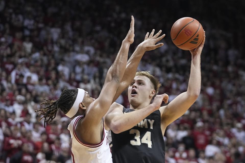 Army's Charlie Peterson shoots over Indiana's Malik Reneau during the first half of an NCAA college basketball game, Sunday, Nov. 12, 2023, in Bloomington, Ind. (AP Photo/Darron Cummings)
