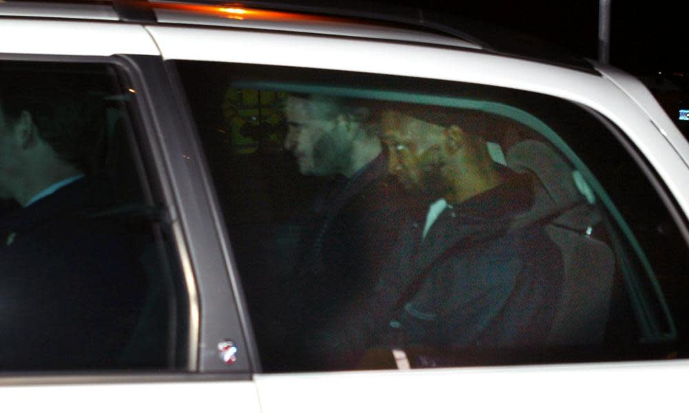 Jamal al-Harith, right, leaves Northolt RAF base, on 9 March 2004 with plain-clothes police officers after being released from custody. 