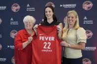 Indiana Fever's Caitlin Clark, middle, poses with general manager Lin Dunn, left, and head coach Christie Sides following a WNBA basketball news conference, Wednesday, April 17, 2024, in Indianapolis. (AP Photo/Darron Cummings)