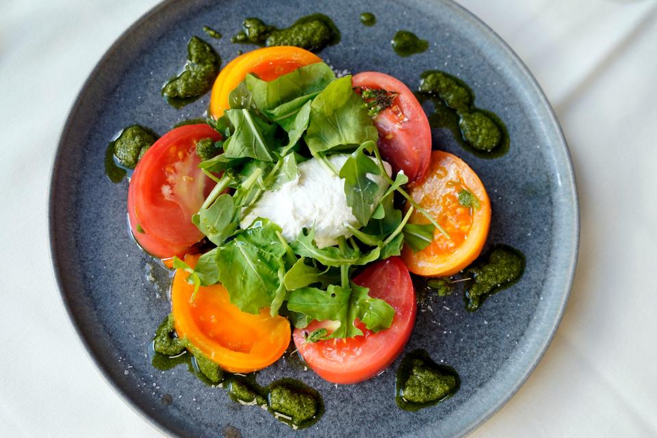 The heirloom tomato salad with pesto, whipped ricotta, and arugula at Cafe Panache in Ramsey, photographed on Wednesday, Aug. 16, 2023.