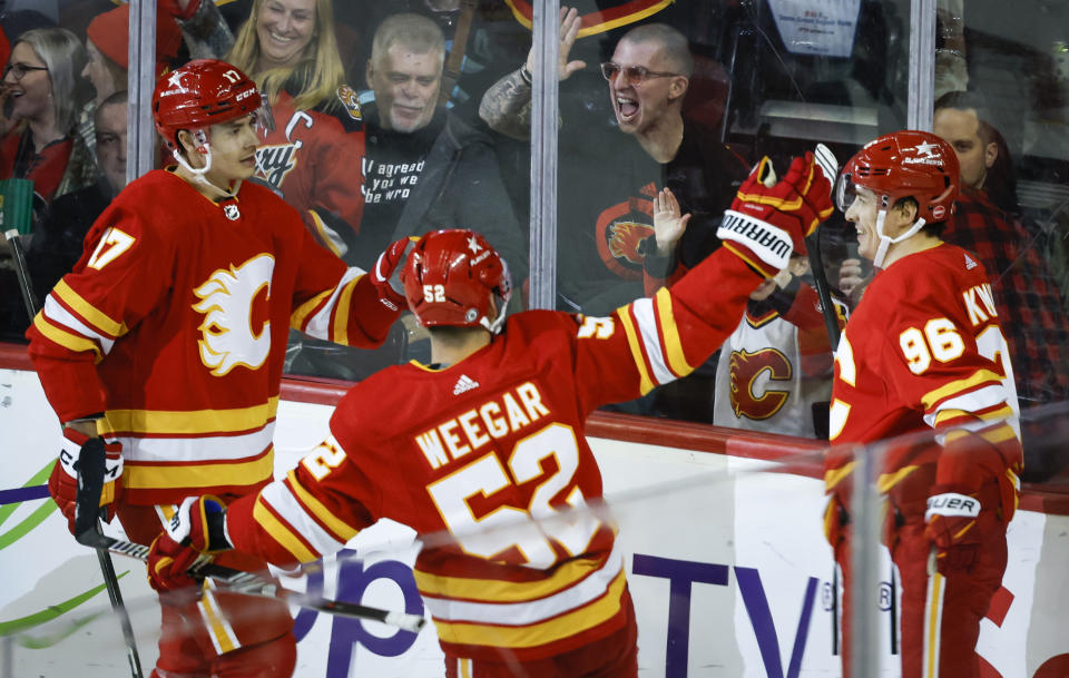 Calgary Flames forward Andrei Kuzmenko (96) celebrates after his goal with teammates during second-period NHL hockey game action against the Seattle Kraken in Calgary, Alberta, Monday, March 4, 2024. (Jeff McIntosh/The Canadian Press via AP)