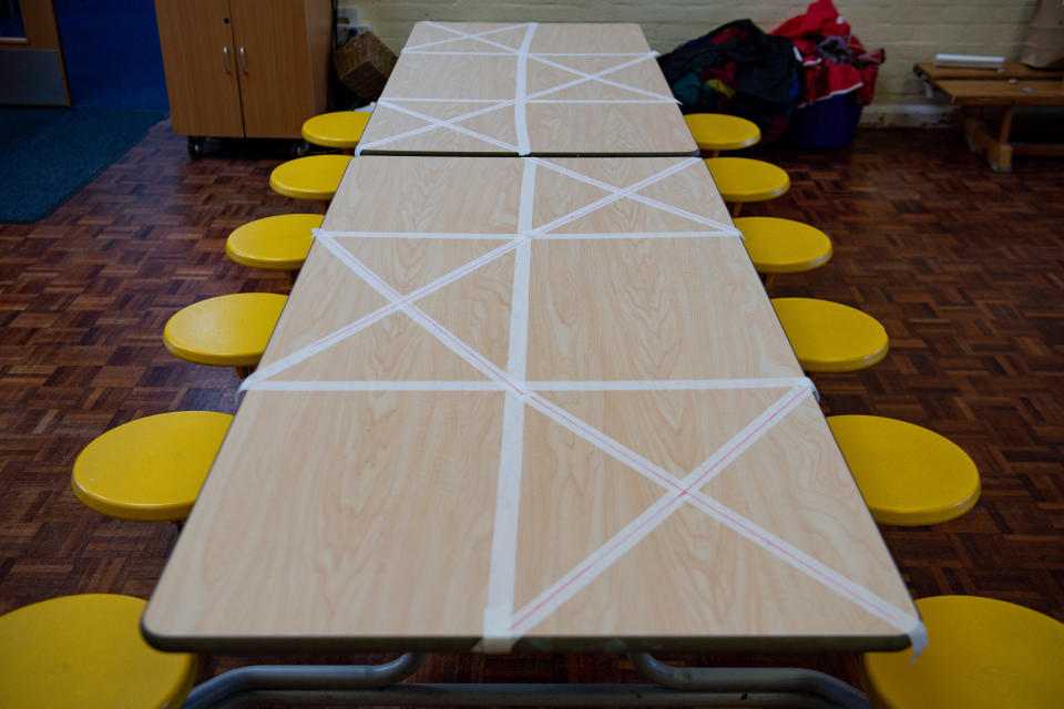 Tables are marked showing where children can sit during lunchtime at Kempsey Primary School in Worcester.