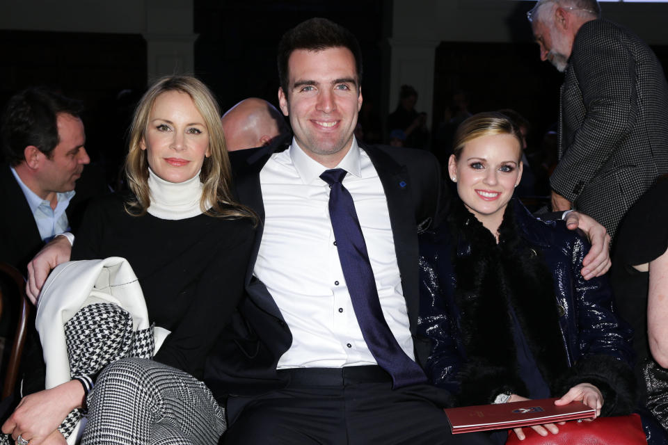 This image released by Starpix shows Dee Hilfiger, wife of designer Tommy Hilfiger, left, with Baltimore Ravens quarterback Joe Flacco and his wife Dana Grady at the Tommy Hilfiger Men's Fall 2013 collection, Friday, Feb. 8, 2013 during Fashion Week in New York. (AP Photo/Starpix, Andrew Toth)