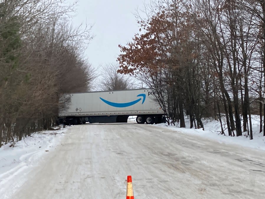 An Amazon truck jackknifed across Holmes.