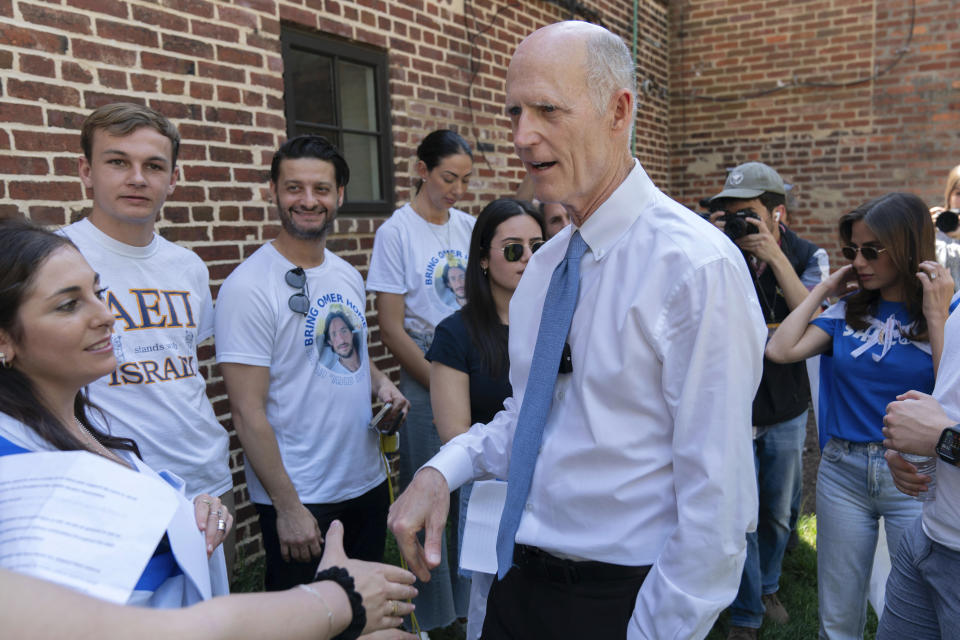 Sen. Rick Scott, R-Fla., shakes hands with supporters of Israel as they demonstrate at George Washington University where pro-Palestinian students protest over the Israel-Hamas war, Thursday, May 2, 2024, in Washington. (AP Photo/Jose Luis Magana)