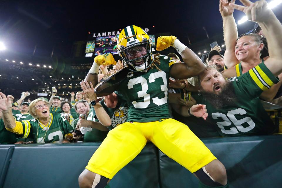 Green Bay Packers running back Aaron Jones (33) celebrates with fans after scoring a touchdown against the Chicago Bears in the second quarter during their football game Sunday, September 18, 2022, at Lambeau Field in Green Bay, Wis. Dan Powers/USA TODAY NETWORK-Wisconsin