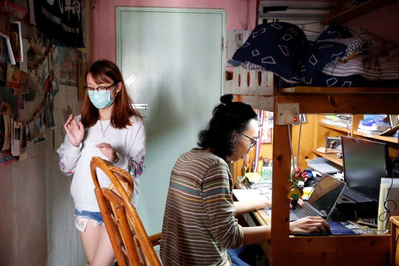 Derek Tai and his girlfriend Ann are seen at his apartment in Hong Kong