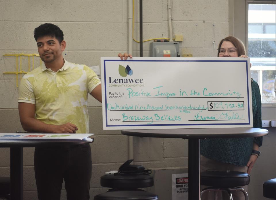 Jose Salazar, left, corporate human resources generalist and a two-year team member with Brazeway, and Paula Trentman, right, vice president and director of grants and programs for the Lenawee Community Foundation, hold up a check May 10 noting the amount of funds raised through the Brazeway Believes campaign and donated to the Lenawee Community Foundation. In 2022, as part of the Lenawee Cares campaign, Brazeway Believes raised $109,792.32 for "Positive Impact in the Community."
