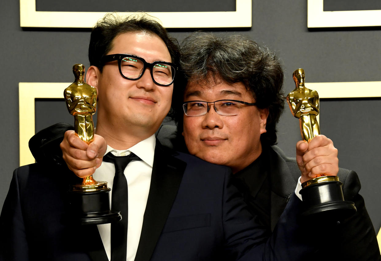 Han Jin-won and Bong Joon-ho with their Oscars for Best Original Screenplay, International Feature Film, Best Director, and Best Picture for Parasite in the press room at the 92nd Academy Awards held at the Dolby Theatre in Hollywood, Los Angeles, USA. (Photo by Jennifer Graylock/PA Images via Getty Images)