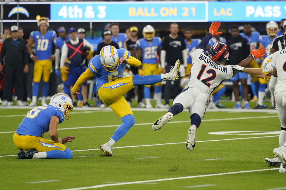 Los Angeles Chargers place kicker Dustin Hopkins (6) kicks the game winning field goal as Denver Broncos wide receiver Montrell Washington (12) tries to block it during the second half of an NFL football game, Monday, Oct. 17, 2022, in Inglewood, Calif. The Chargers defeated the Broncos 19-16 in overtime. (AP Photo/Mark J. Terrill)