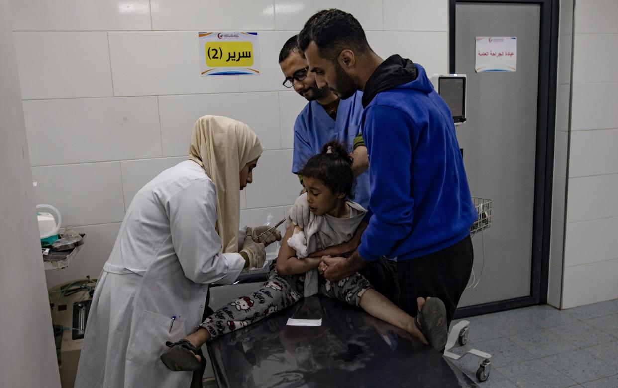 An injured Palestinian child receives treatment at Kuwait Hospital following an Israeli air strike in the Rafah refugee camp