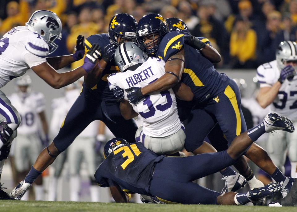 The West Virginia Mountaineers defense stops John Hubert #33 of the Kansas State Wildcats during the game on October 20, 2012 at Mountaineer Field in Morgantown, West Virginia. (Photo by Justin K. Aller/Getty Images)